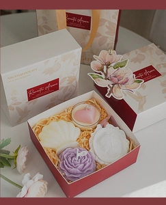 Detail of luxury aromatherapy gift set with shell candle and floral packaging box