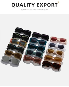 Flat lay of vintage rectangular sunglasses in fourteen assorted colors on grey backdrop