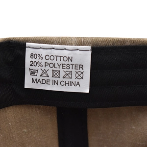 Detail view of cotton baseball cap washing label showing material composition and care instructions