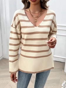 Detailed close-up of V-neck striped sweater with ribbed cuffs and hemline detail