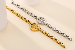 Macro view of gold and silver Hamsa hand bracelets with cubic zirconia paving