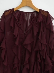 Deep burgundy V-neck chiffon blouse featuring layered ruffles on a wooden hanger