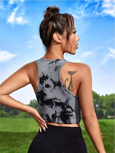 Outdoor side view of a gray tie-dye seamless ribbed knit racerback yoga tank top