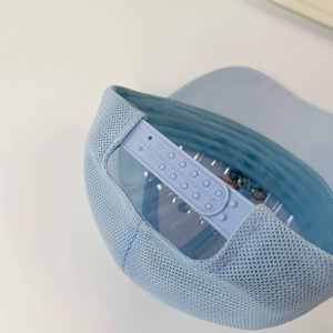 Detail of adjustable snapback closure and breathable mesh on a light blue kids baseball cap