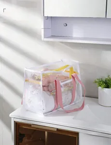 Waterproof PVC mesh travel storage bag with pink handle on bathroom counter