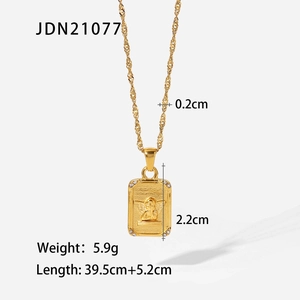 Macro shot of 18K gold plated angel relief pendant with diamond accents and wavy chain