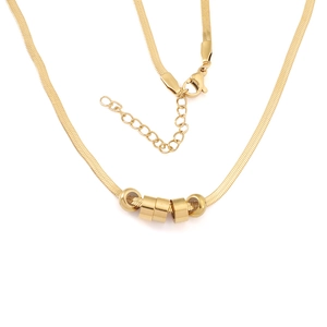 Gold snake chain necklace with five polished bead pendants shown on white background