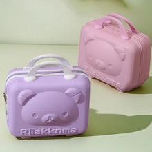 Close-up of pink and purple mini hard shell suitcases with 3D cute bear face design