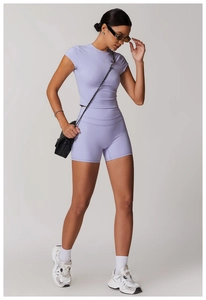 Full view of light purple athletic two-piece set with cropped t-shirt and high waist shorts