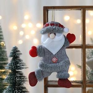 Detail of Santa Claus ornament with grey plaid hat and snowflake button hanging on wood