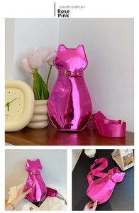 Detail of rose red cat-shaped handbag featuring glossy metallic leather and adjustable collar