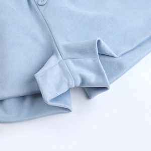 Macro shot of light blue suede fabric shorts with detailed flat-felled seam stitching