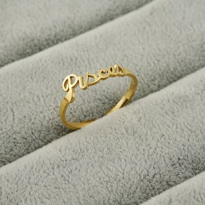 Gold Pisces zodiac stainless steel open ring displayed on a grey velvet jewelry box