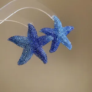 Sparkling gradient blue starfish pendant earrings with crystal stones for a summer beach look