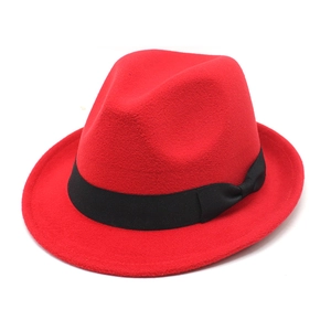 Detail of red wool fedora hat featuring a black grosgrain ribbon and classic bow accent
