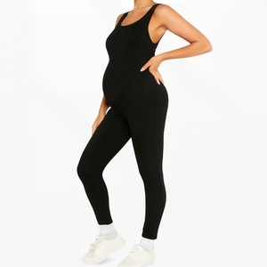 Detailed side view of black maternity jumpsuit showing elastic support for baby bump