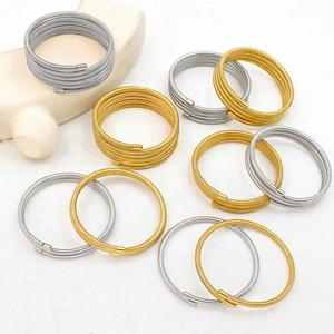 Detailed macro view of multilayer spring coil bracelets in polished gold and silver finishes