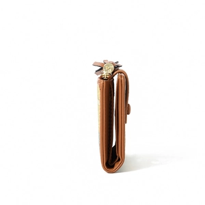Side view detail of a brown leather wallet showing multi-layer structure and tassel