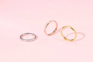 Close-up of minimalist matte textured rings in silver, rose gold, and gold finish