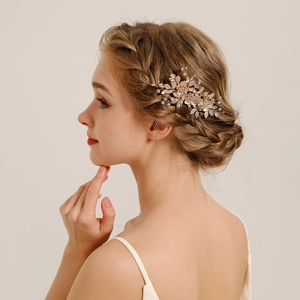 Elegant gold flower bridal hair comb with rhinestones and leaves on model