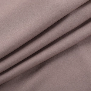 Macro view of mauve knitted fabric showing soft texture and premium weave detail