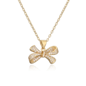 18K gold plated bow pendant necklace with sparkling zircons on a white background