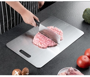 Detailed view of slicing meat on a SUS 304 stainless steel chopping board with handle