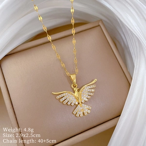 Macro shot of gold phoenix pendant necklace with zircon inlay and product dimensions