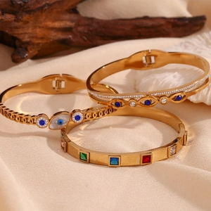 Detail of 18K gold-plated beaded bracelets featuring colorful zircon and evil eye designs