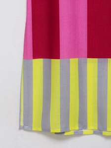 Detailed view of striped patchwork fabric in red and yellow with cotton linen texture
