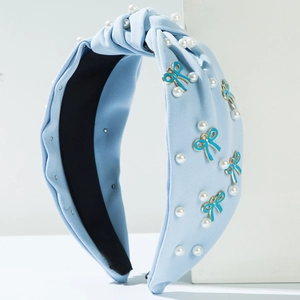 Light blue knotted fabric headband with pearls and blue enamel bow alloy charms