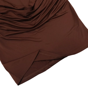 Detail of dark brown dress hem featuring pleated fabric texture and double-needle stitching