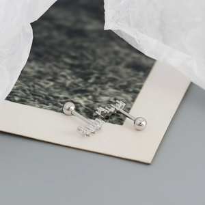 Macro detail of geometric S925 sterling silver screw back earrings with sparkling zircon stones