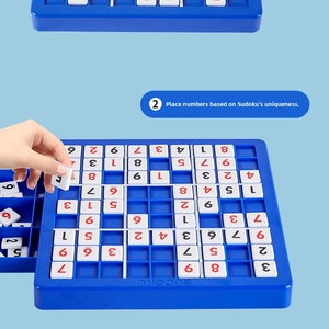 Close-up of children placing number tiles on a blue Sudoku logic puzzle board