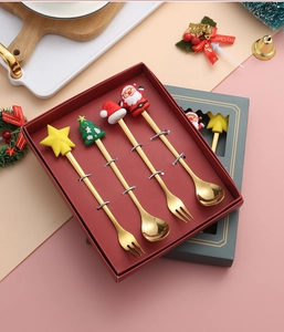 Detailed view of 4pcs gold stainless steel Christmas cutlery set in a red gift box