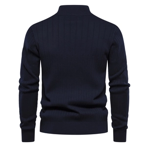 Detail view of the back of a navy blue knit sweater featuring a vertical ribbed texture