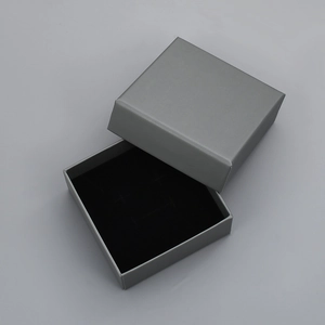Macro view of silver square jewelry gift box with premium black velvet inner padding
