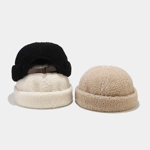 Detailed view of plush faux lamb wool docker hats in black, beige, and khaki colors