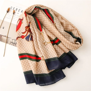 Detailed view of autumn scarf with horse carriage print and elegant beige plaid patterns