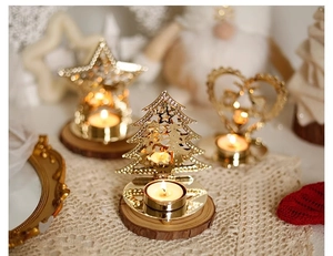 Close-up of golden metal hollow candle holders in star, tree, and heart shapes