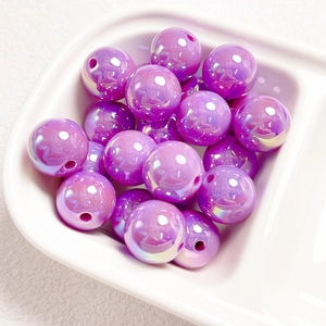 Macro shot of purple iridescent acrylic beads with UV pearl finish for DIY jewelry crafts