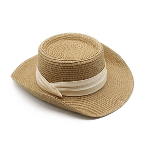 Flat top straw sun hat with woven texture and cream satin ribbon for summer beach vacation
