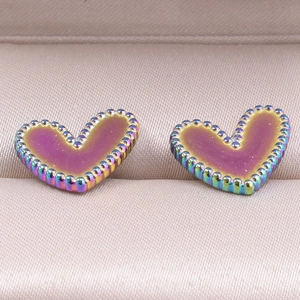 Macro view of heart-shaped stainless steel earrings with iridescent rainbow plating