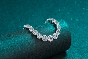 Macro shot of silver S925 bracelet with round-cut moissanite stones and micro-pave halo
