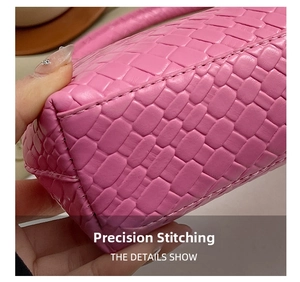 Detailed close-up of pink woven texture and precise stitching on the shoulder bag