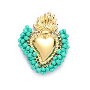 Sacred heart pendant with gold metal flame and turquoise beads on white background