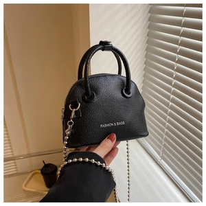 Detail of black lychee texture shell bag with Fashion & Bags print and silver bead chain