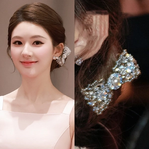 Detail view of silver bow earrings with crystals and pearls on model and in close-up