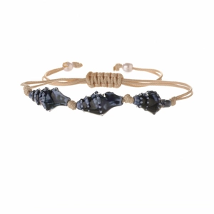 Handmade woven bracelet with blue ceramic shell beads and pearls on a white background