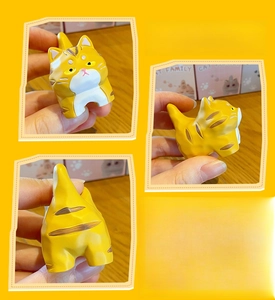 Three-sided view of a yellow striped resin cat figurine with smooth wood-carved texture
